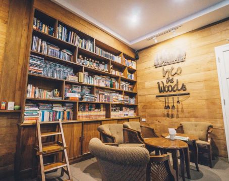 Bookshelf corner and seating inside Into the Woods Cafe
